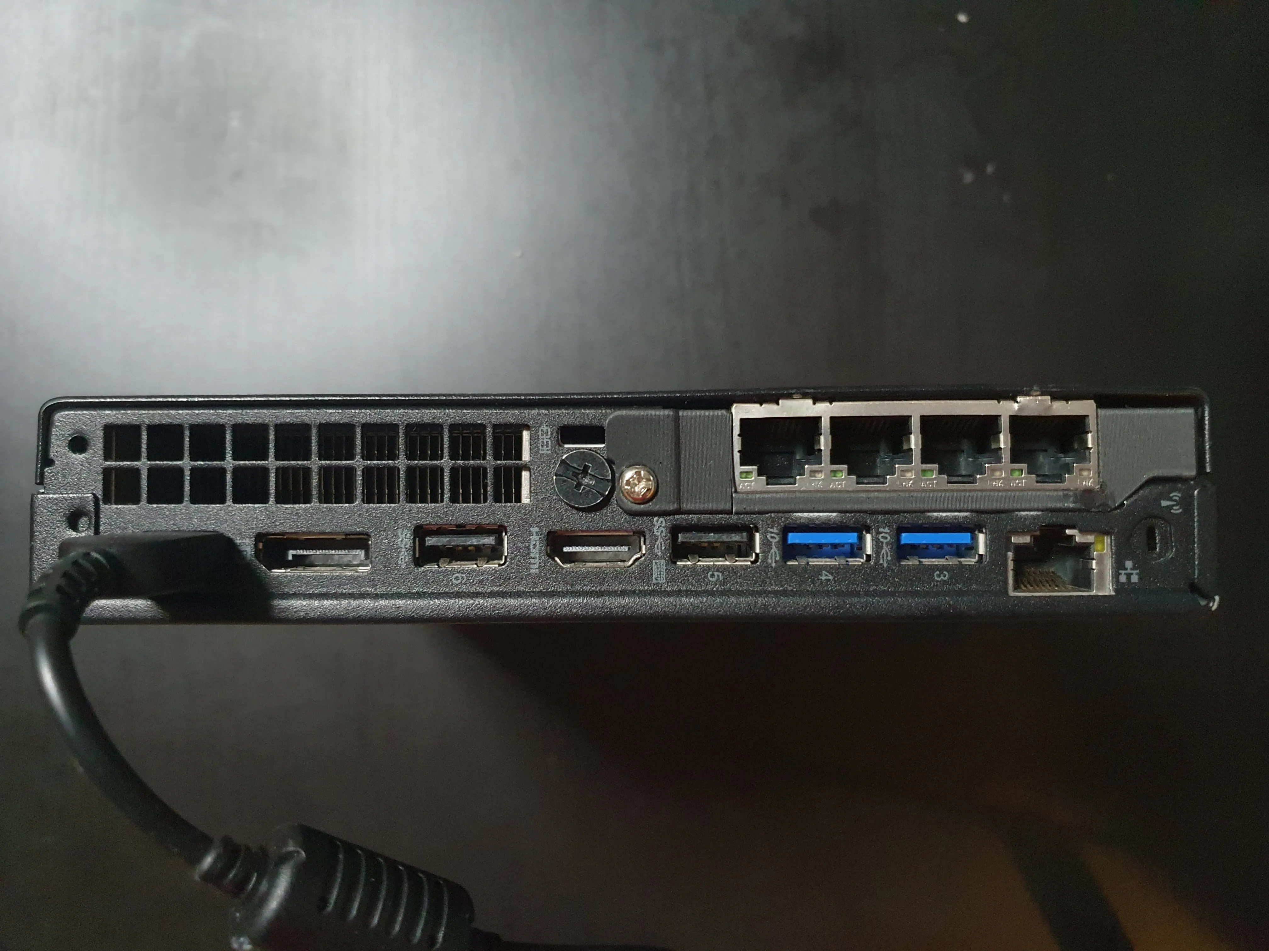 Completed M920q build with 3D printed IO shield covering quad NIC ports